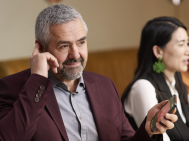 A man pairing his hearing aid to his phone