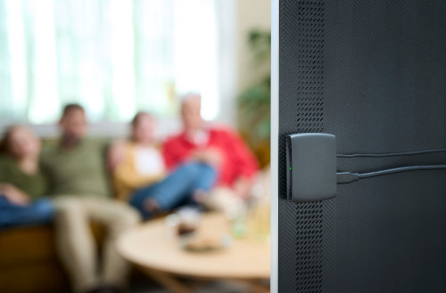 A family watching TV with the ReSound TV-Streamer+
