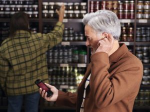 A man pairs his hearing aid to his phone